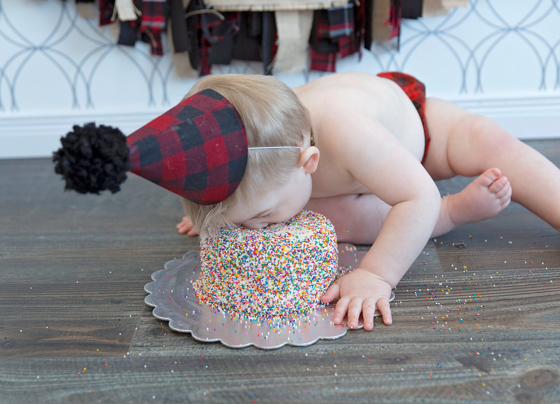 Cake Smash birthday photo session baby putting his whole face in a cake