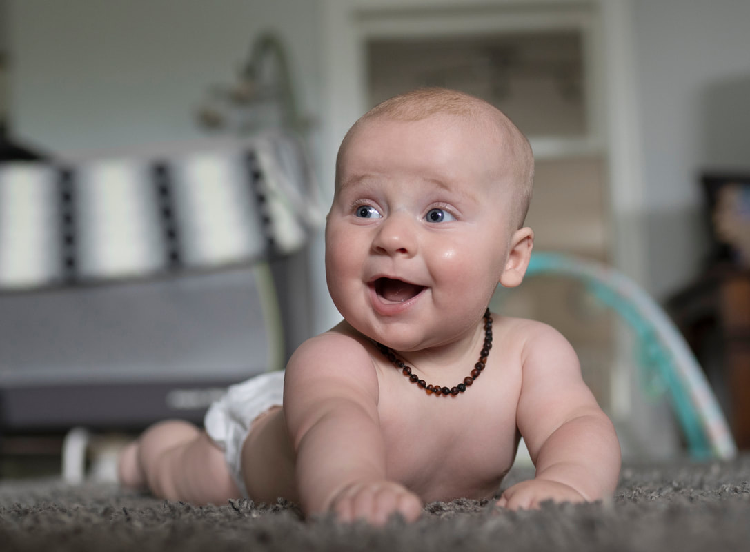 Baby on his tummy laughing photo