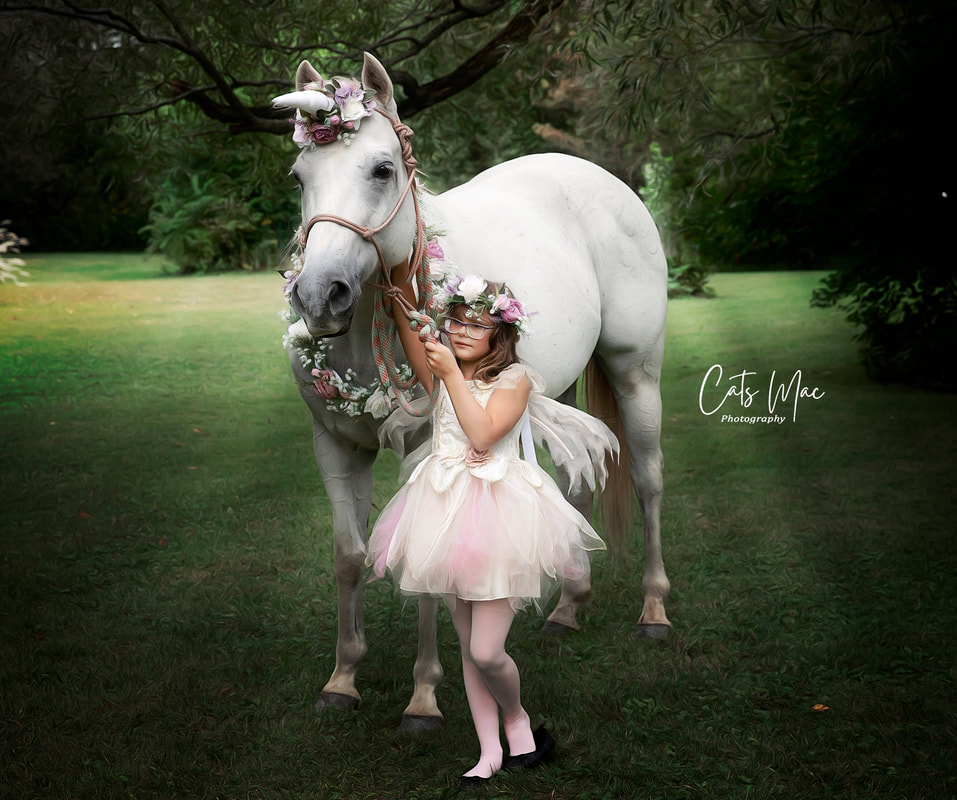 Little girl in princess dress walking next to a unicorn