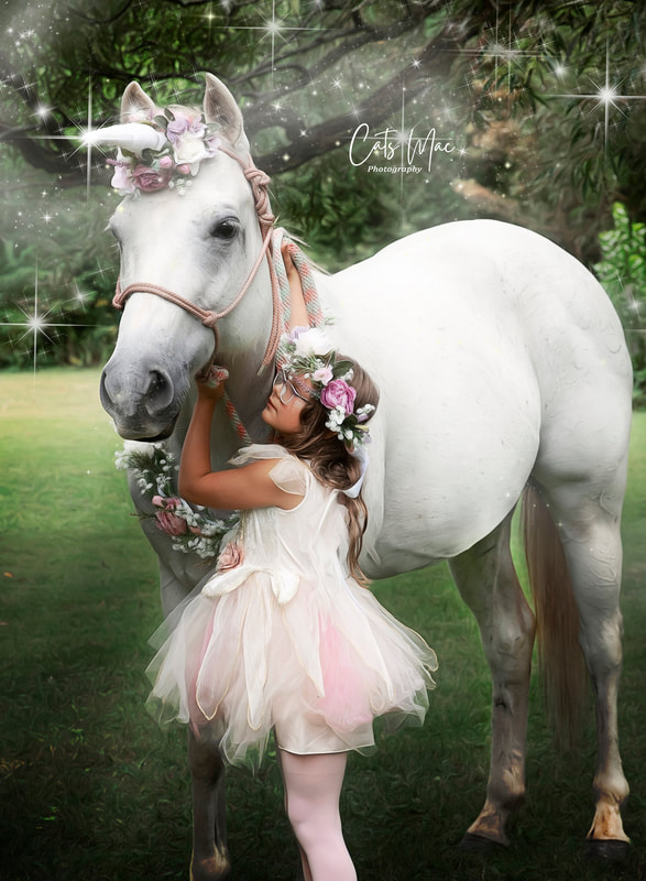 girl in princess dress hugging the neck of a unicorn with magical stars around