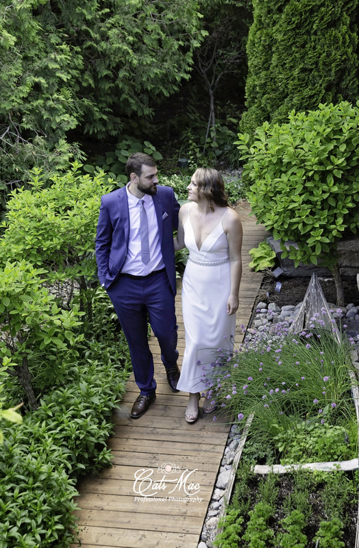 Walking among lush greenery bride and groom