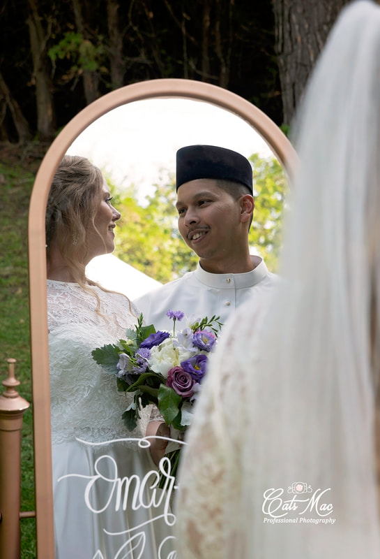 Bride and groom muslim looking in mirror