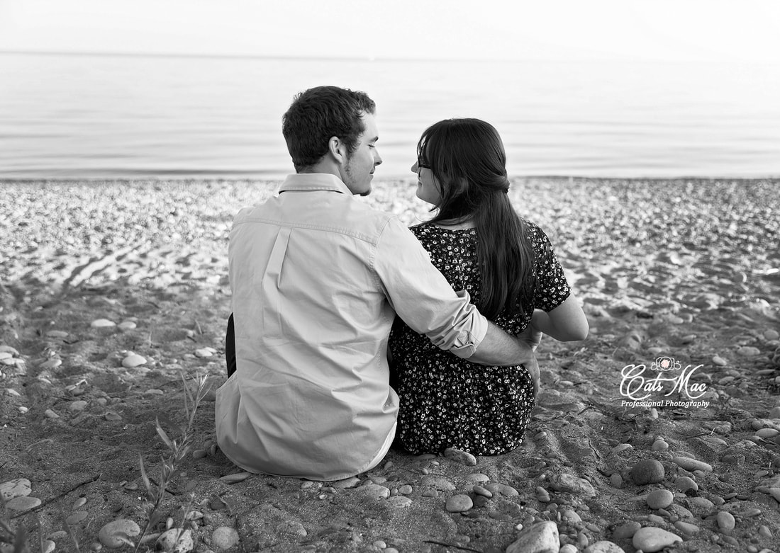 Black and white engaged couple Cobourg Beach