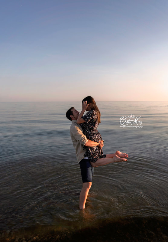 Engagement photo session couple in water Cobourg Beach