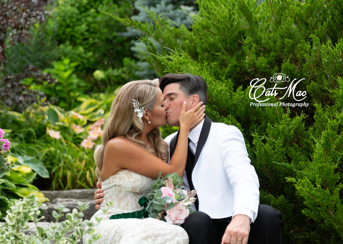 Stillwater on the lake kissing just married groom bride gardens elopement