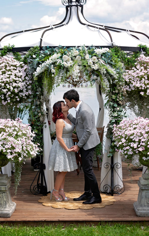 First kiss under the flowers and gazebo at Stillwater on the Lake Peterborough