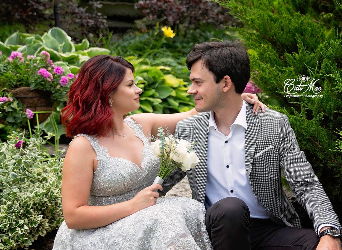 Bride and Groom sitting in garden elopement at Stillwater on the Lake Peterborough