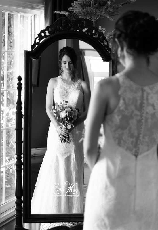 black & white bride looking in mirror bouquet Stillwater on the Lake elopement