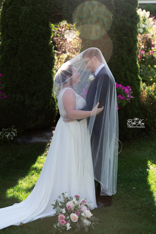 Stillwater on the Lake bride and groom under veil gardens 