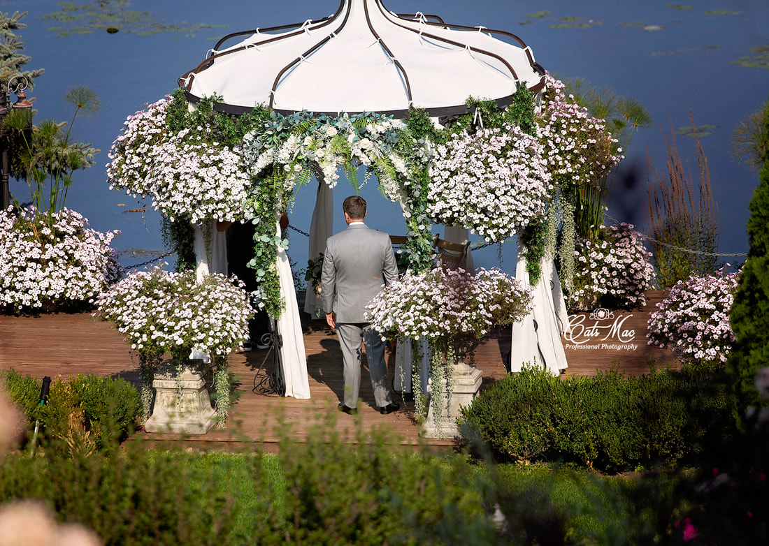 Stillwater on the Lake Chemong first look groom waiting for bride under arbour elopement