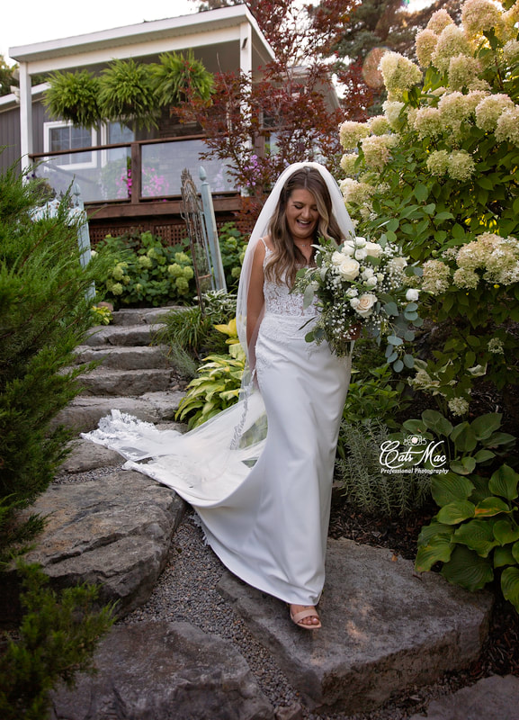 Stillwater on the Lake intimate elopement bride walking down steps in garden