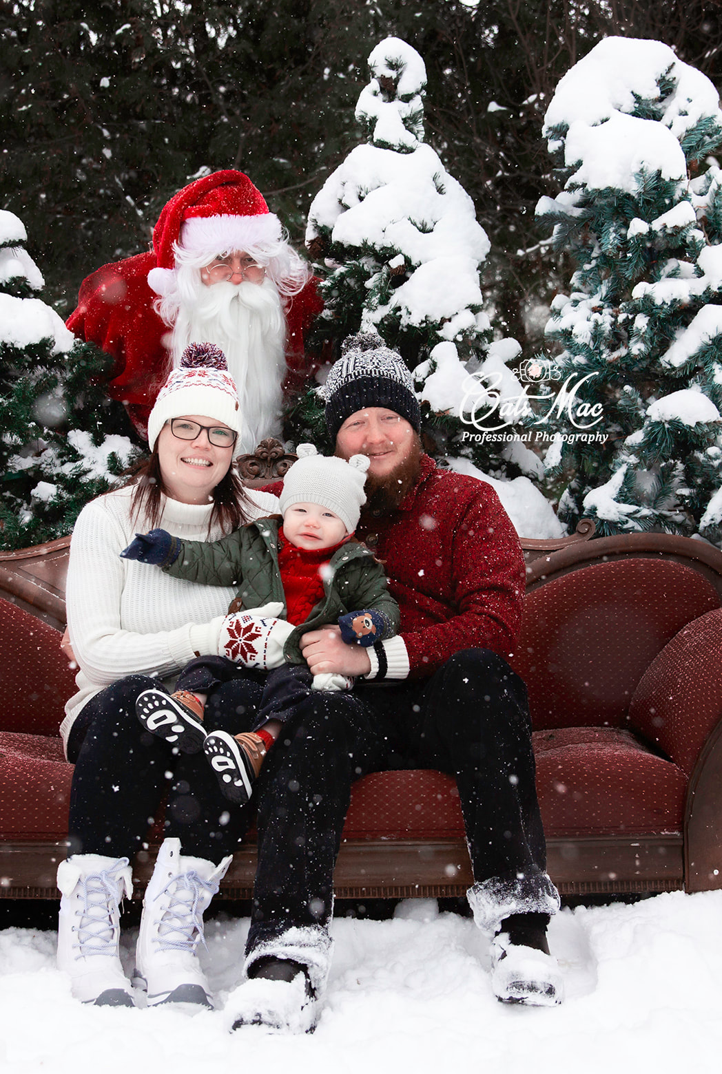 Outside snowing Santa red couch Christmas photo session mini