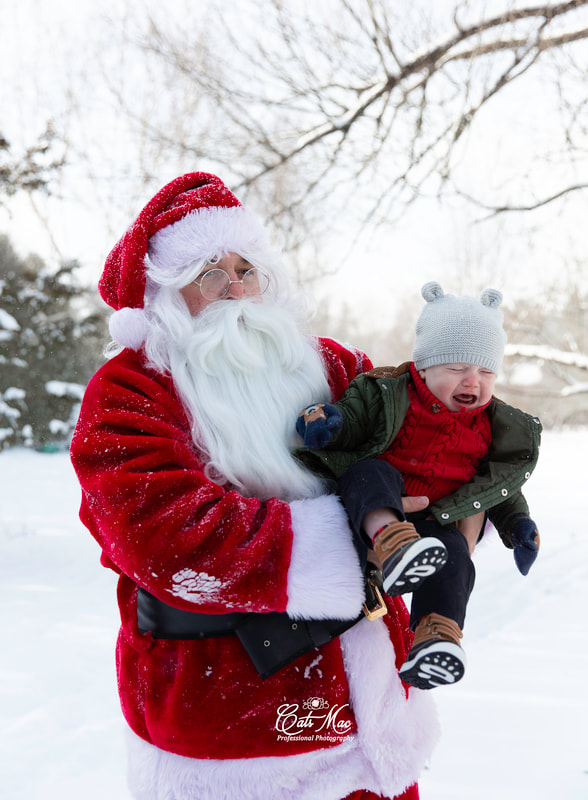 Santa holding a crying baby outside