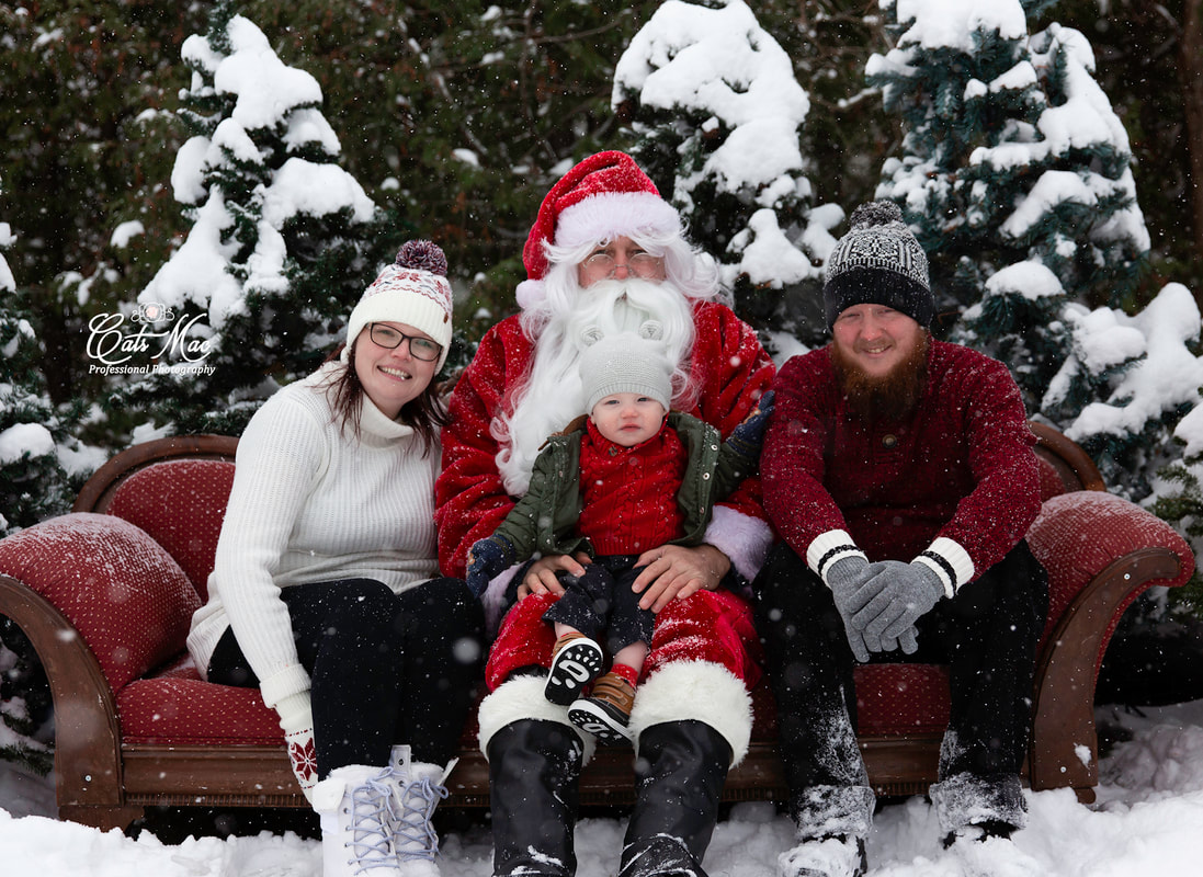 Outside snowing Santa red couch family photos