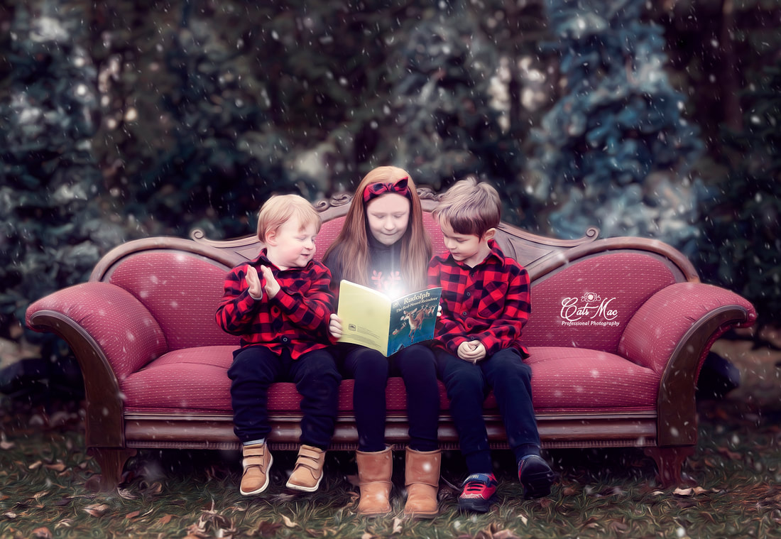 Kids on red couch outside reading book christmas photo