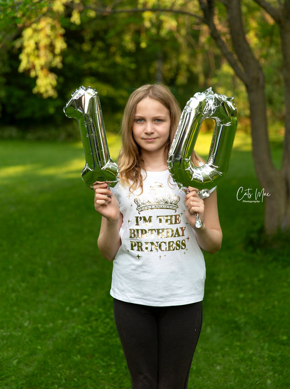 10th birthday celebration photo shoot girl holding up number 10