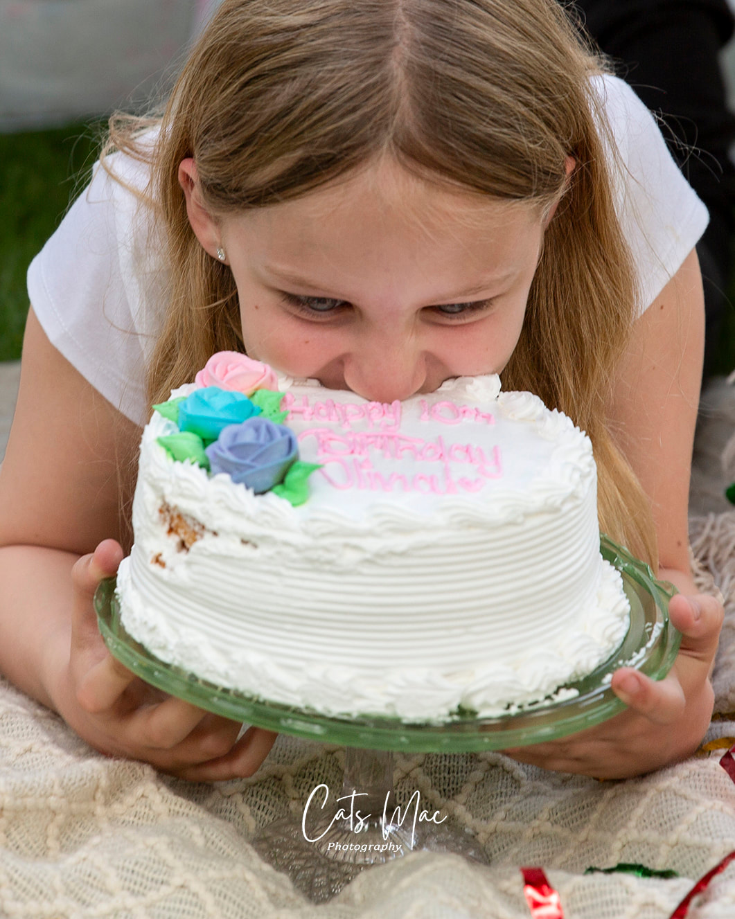Girl digging into her 10th birthday cake photo shoot