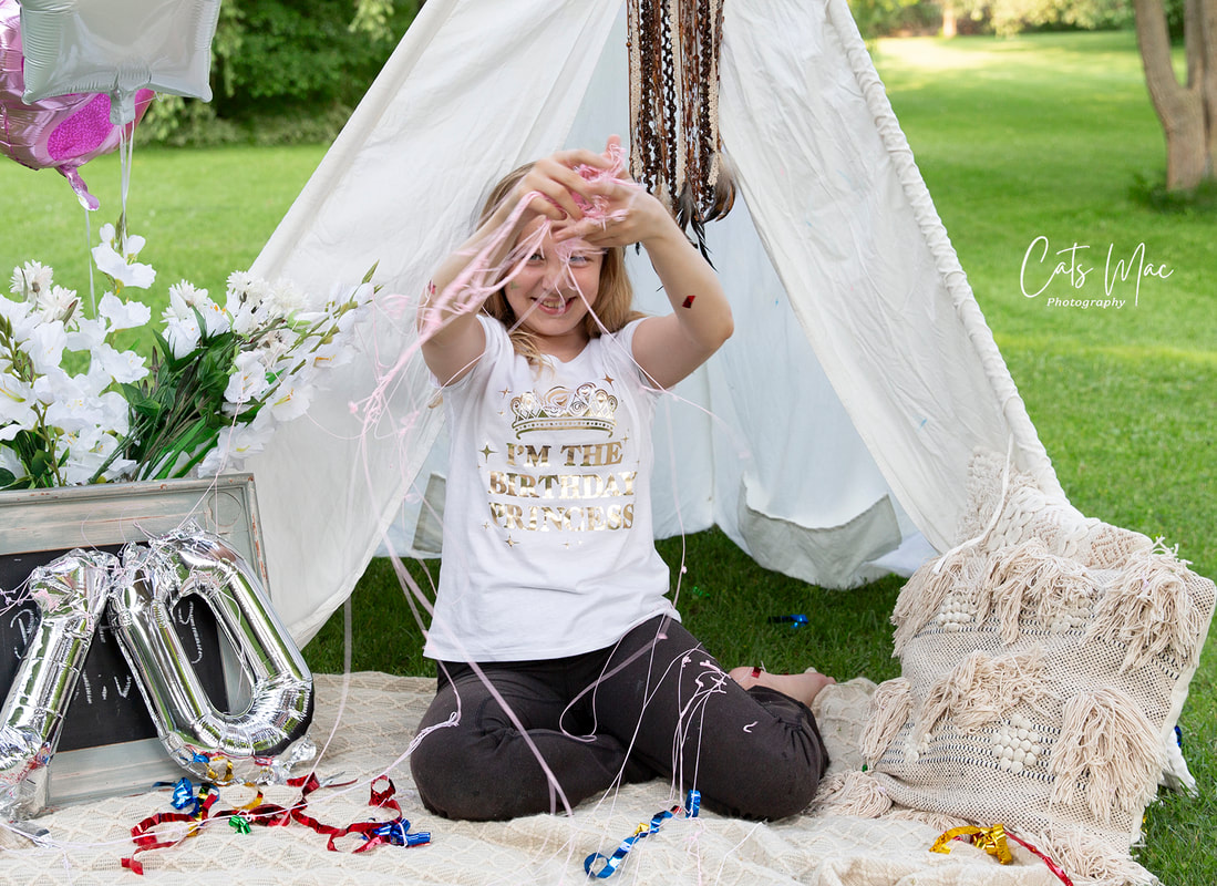 Girl in front of teepee celebrating her 10th birthday with silly string photo shoot