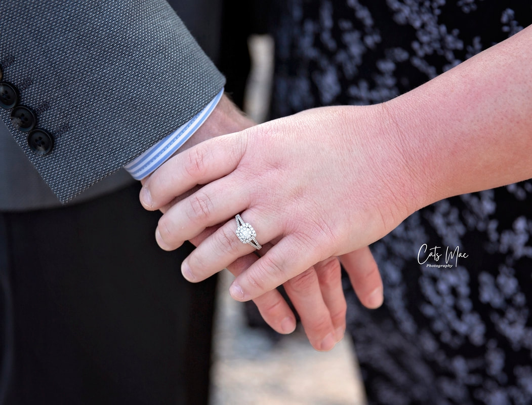Photo of engagement ring on woman's hand 
