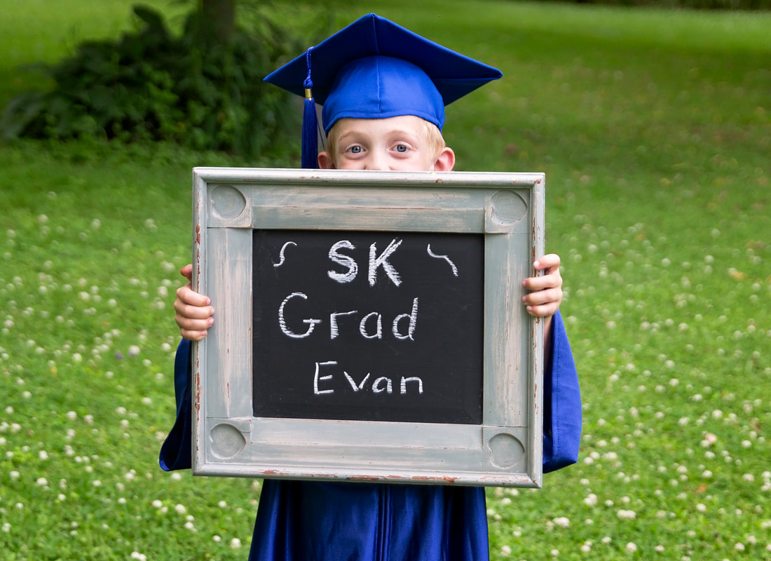 Photo session Kindergarten graduate holding sign outside SK grad