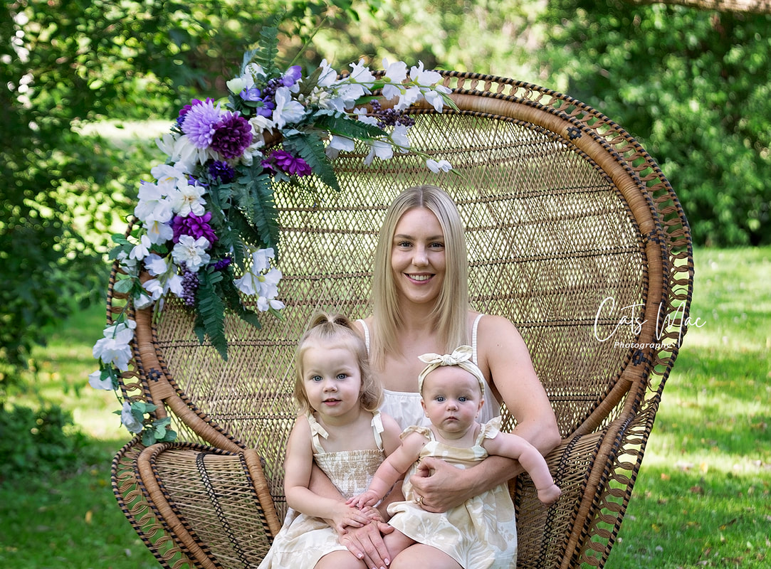 Mom and little girl and baby on a peacock chair photo family session outside summer
