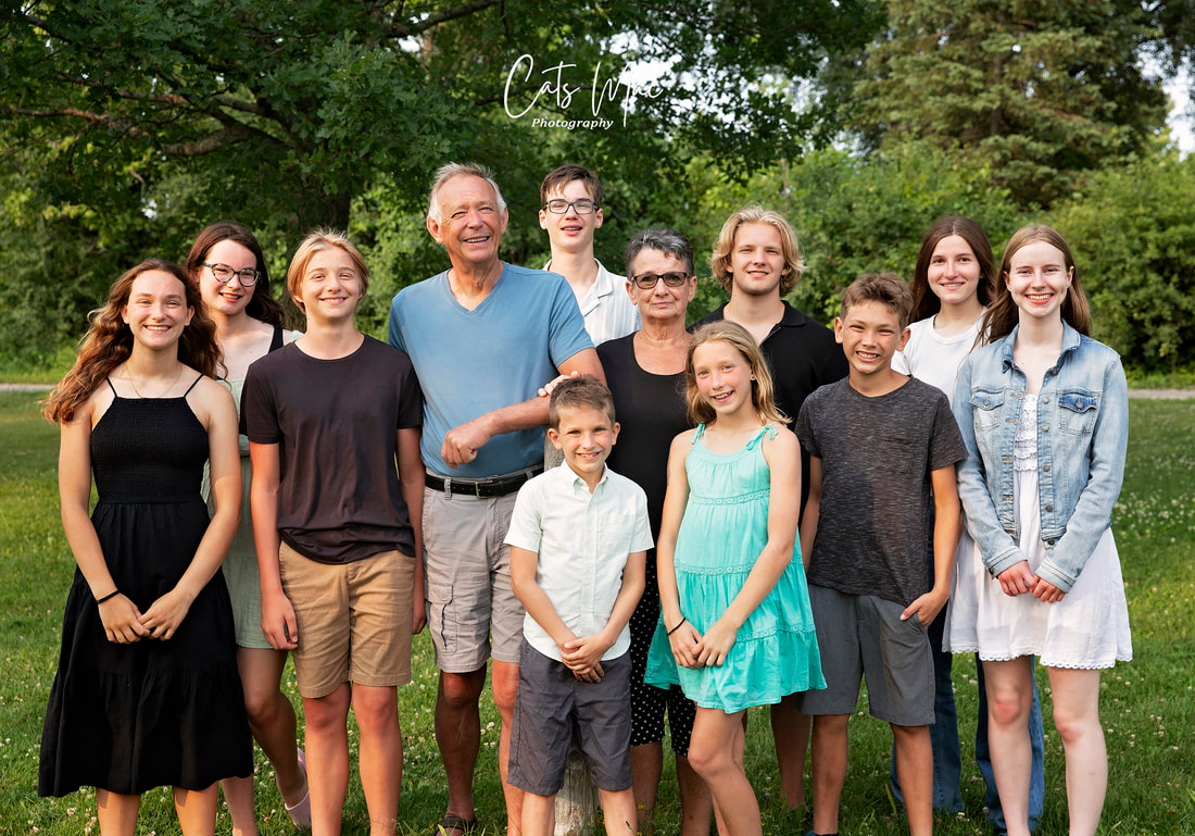 Family photo session of Grandparents surrounded by all their grandchildren family photo