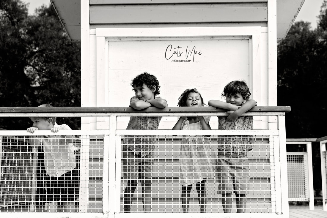 black and white photo of kids on a lifeguard stand at Cobourg Beach 