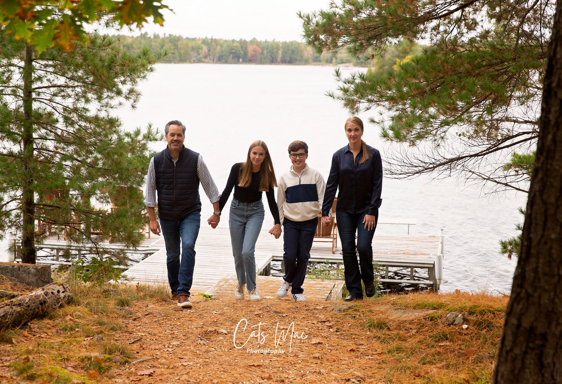 Mother, Father, brother and sister walking up from dock on Stoney Lake 