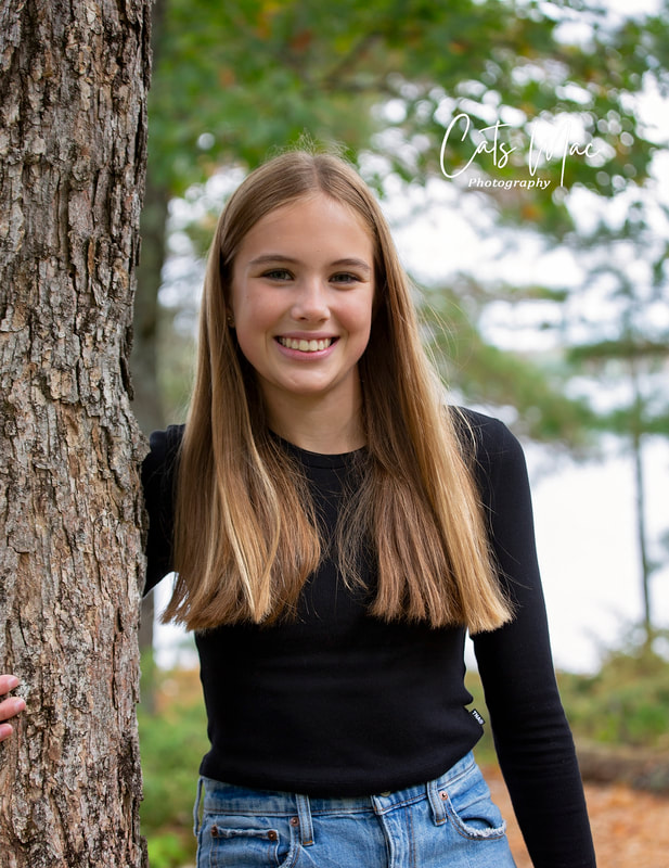 Girl leaning up against tree family photo shoot Stoney Lake Ontario 