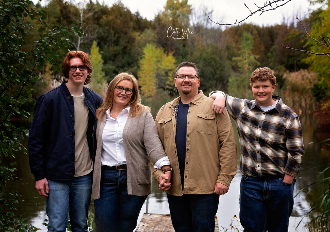 Mother Father and brothers in front of large pond fall family photo session 