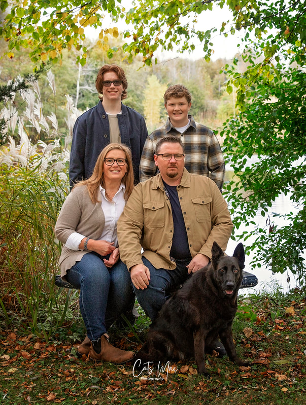 Fall family photo shoot with black dog