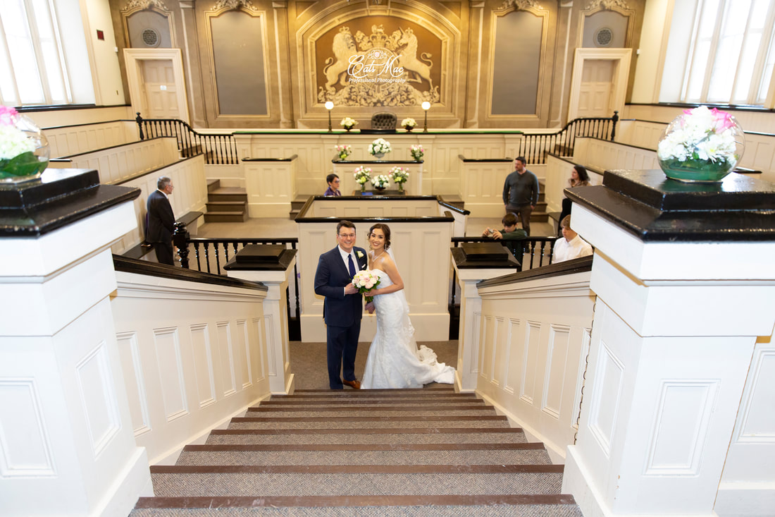 Bride and groom at alter in Courtroom at Cobourg's Victoria Town Hall