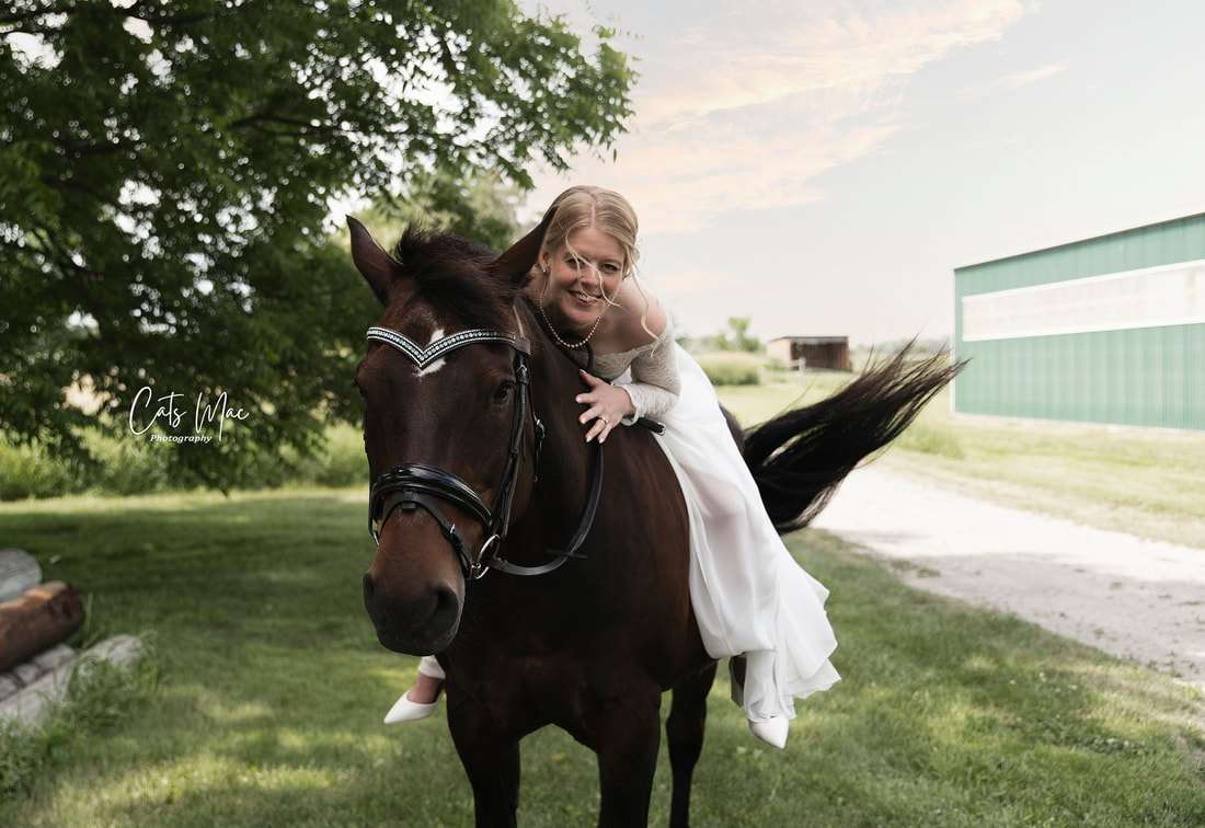 bride on back of horse hugging horse's neck