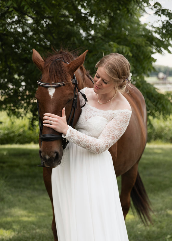 Bride looking at horse