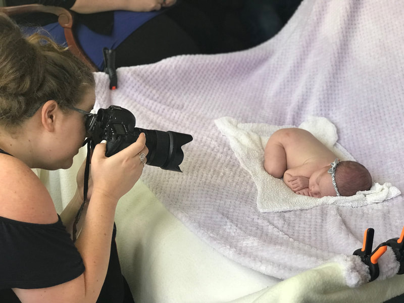 Jenn Schofield photographer with newborn 