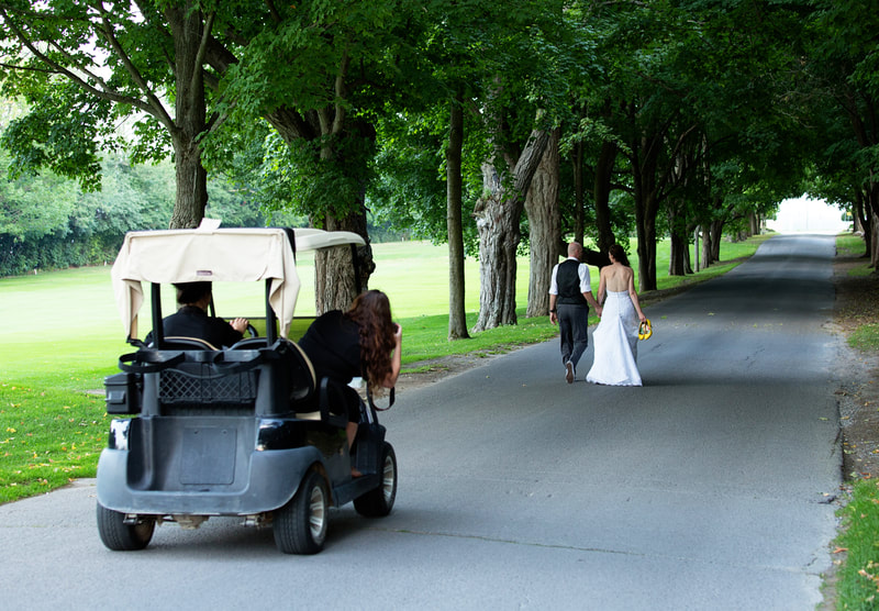 Justin Jenn Schofield wedding photographers in golf cart bride and groom walking
